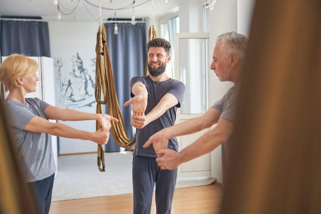 Happy coach working out with his clients